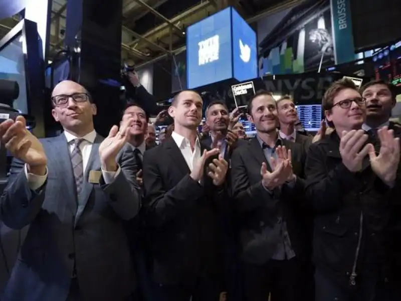 Twitter CEO Dick Costolo Chairman and co founder Jack Dorsey and co founders Evan Williams and Biz Stone left to right applaud as they watch the the New York Stock Exchange opening bell ring on Nov 