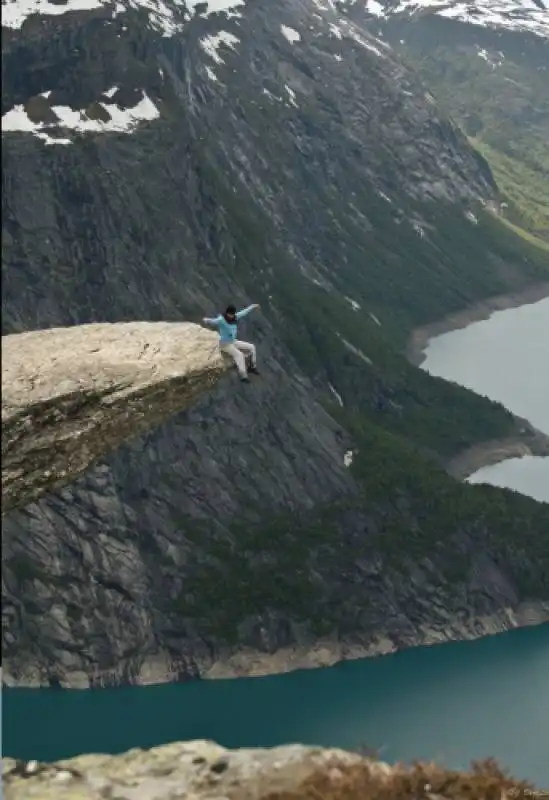 5. sitting on the trolltunga rock in norway