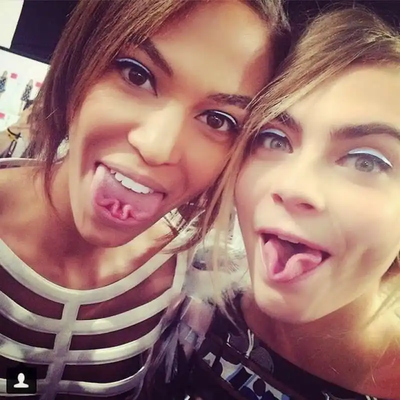 joan smalls and cara delevingne they face in photo