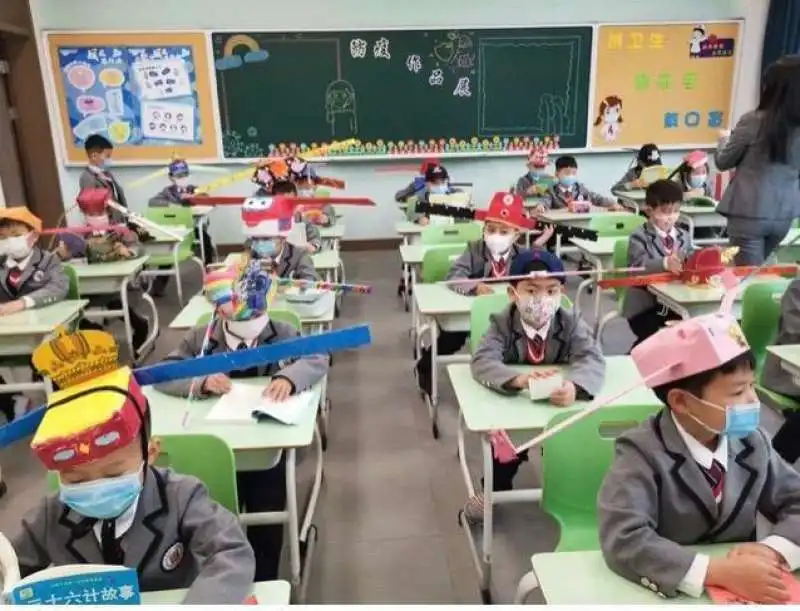 CINA - I BAMBINI CON IL CAPPELLO CON IL METRO PER IL DISTANZIAMENTO