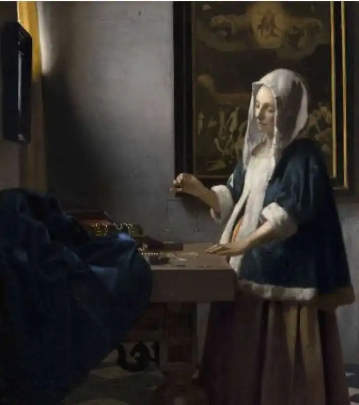 woman holding a balance   johannes vermeer