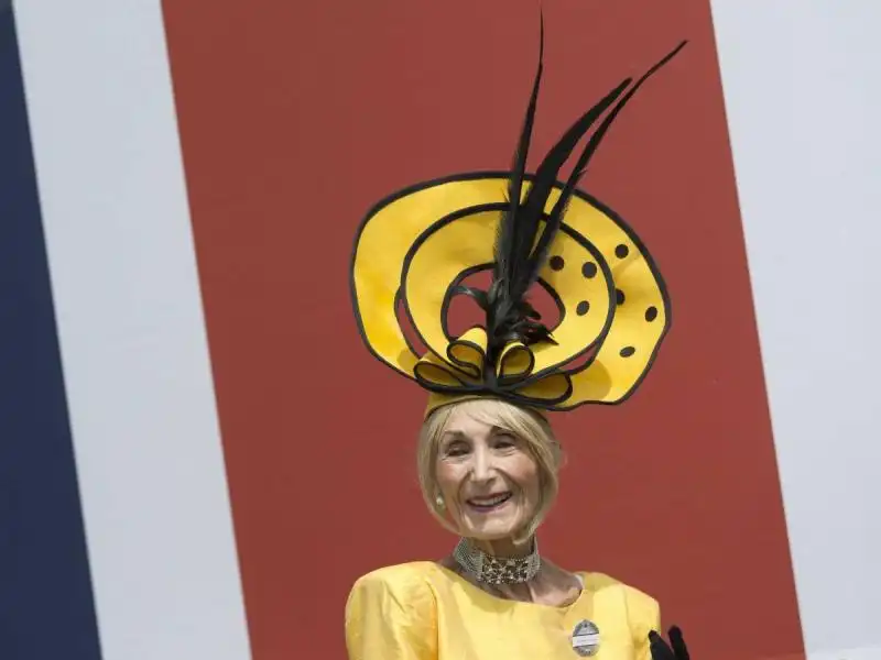 socialite and famed hat wearer florence claridge smiled for the cameras in a unique yellow number 