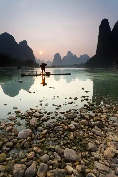 chinas li river is known for its jagged limestone peaks bubbling streams water buffalo and cormorant fishing 