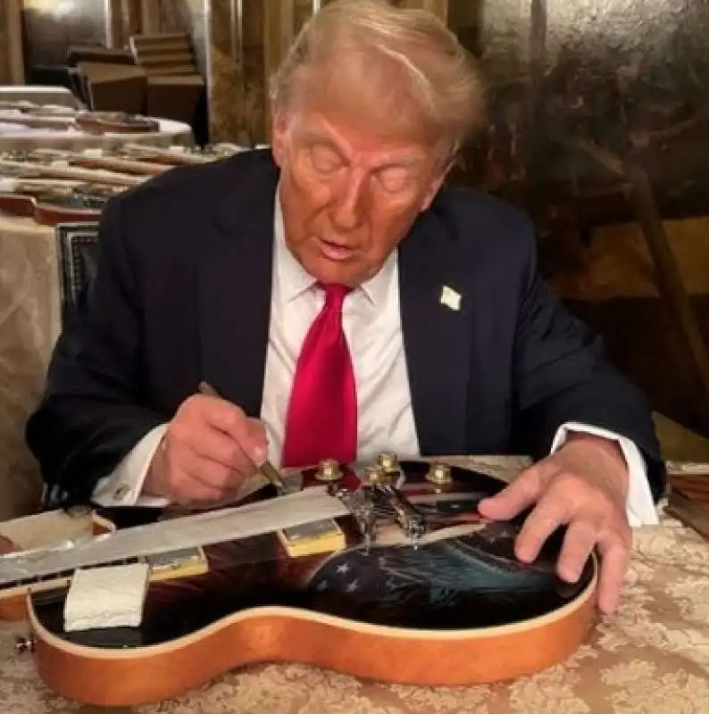 donald trump autografa la chitarra maga 