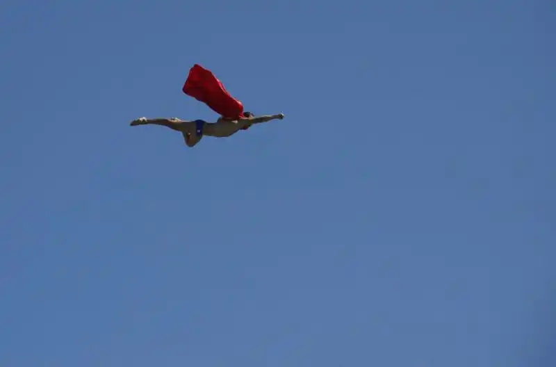 a man dressed as superman dives off the meter high dive in barcelona 