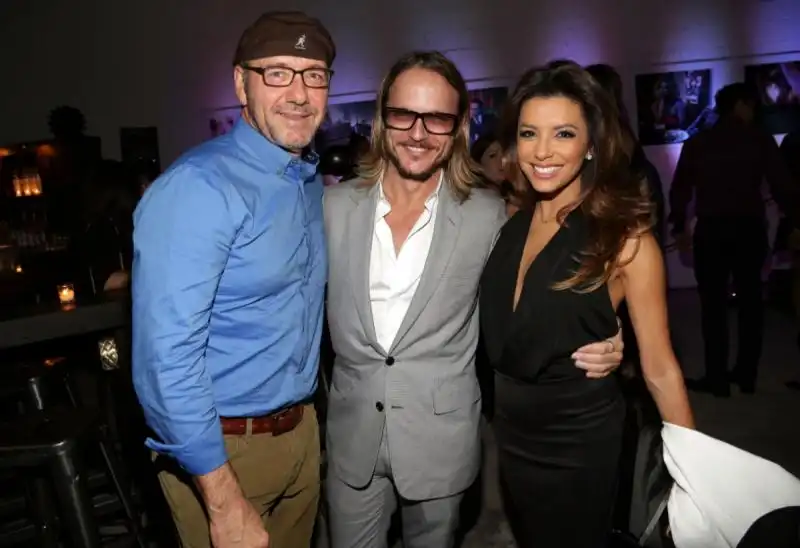 kevin spacey photographer randall slavin and eva longoria attended moments in motion an exclusive unveiling of never before seen photos at de nolet  