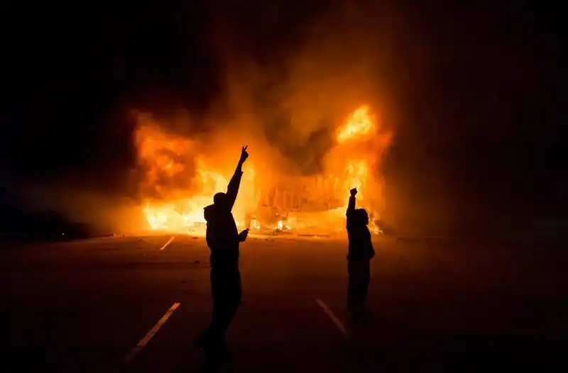 demonstrators stood before a burning autozone.