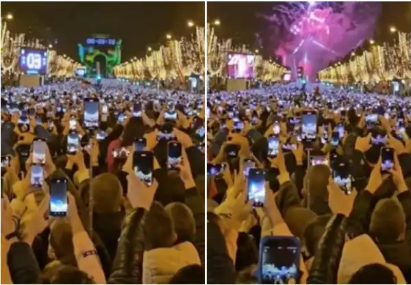 marea di telefonini a mezzanotte sugli champs elysees a parigi