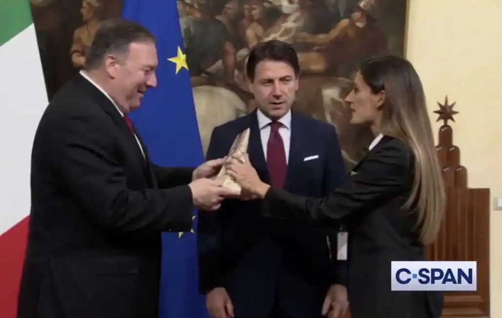 la iena alice martinelli consegna un pezzo di parmigiano a mike pompeo giuseppe conte